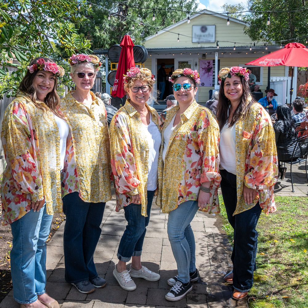 women at wine event in sutter creek with flowers in their hair